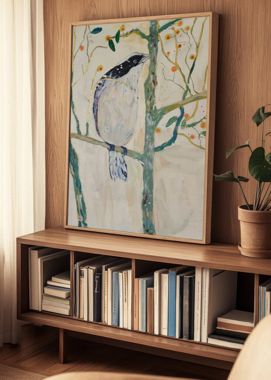 Framed Bird no. 3 poster displayed on a wooden bookshelf in a cozy Nordic living room setting
