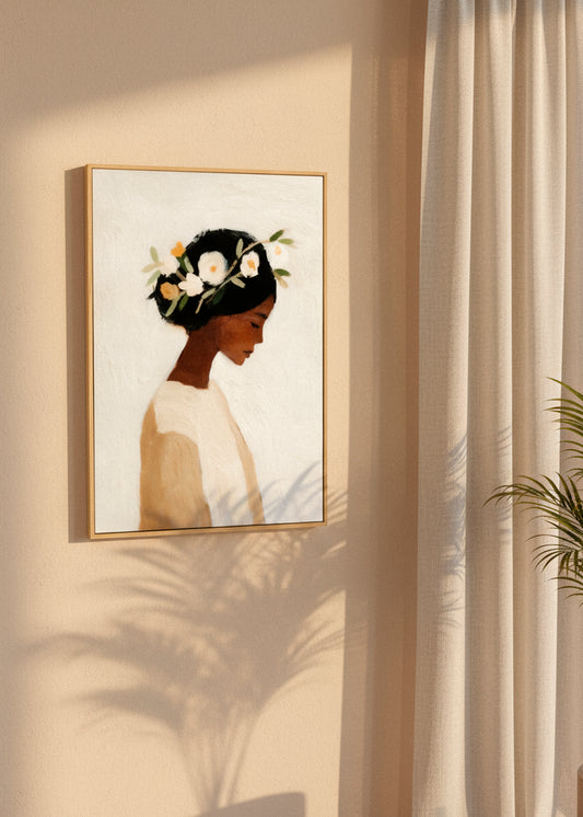 “Saint” canvas print featuring a serene portrait of a woman with white flowers in her dark hair. Displayed in a minimalist bedroom with soft natural light and wooden details.