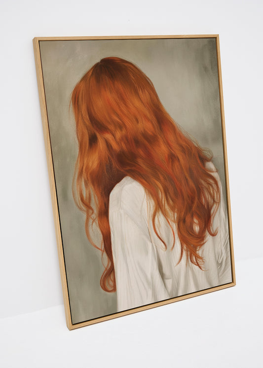 Close-up of the Red Hair canvas print featuring a woman with long, wavy red hair seen from behind, set against a soft grey background. The artwork is displayed in a slim wooden frame, leaning against a white wall.