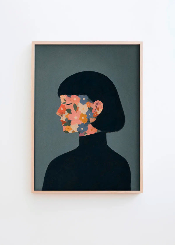A Face I Once Knew floral woman poster featuring a dark-haired woman in profile with colourful flowers across her face on a blue-grey background.