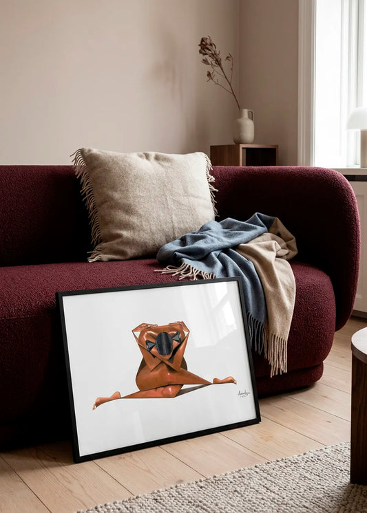 Abstract Geometric Splits by Manasseh Johnson Sr. – framed figurative art poster featuring a woman in a full side split with black geometric details, styled in front of a deep burgundy sofa in a warm neutral living room.