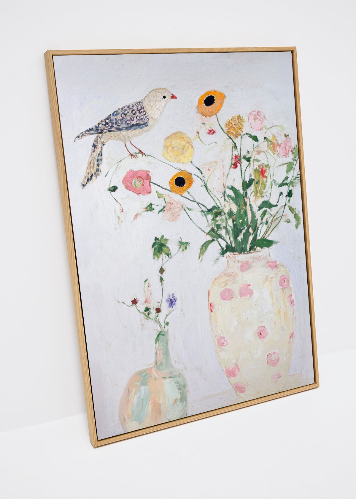 Bird no. 1 canvas print featuring a painted bird and pastel flowers on a white background in a light oak frame