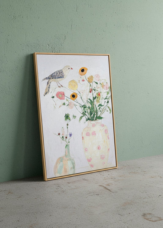 Bird No. 1 canvas print leaning against a green textured wall, showcasing a delicate bird perched above pastel flowers in soft, airy colours. Hello Poster wall art.
