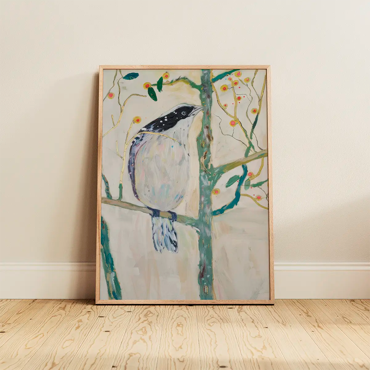 The ‘Bird No. 3’ poster in an oak frame leaning on a wooden floor against a light wall, featuring a delicate pastel bird illustration.