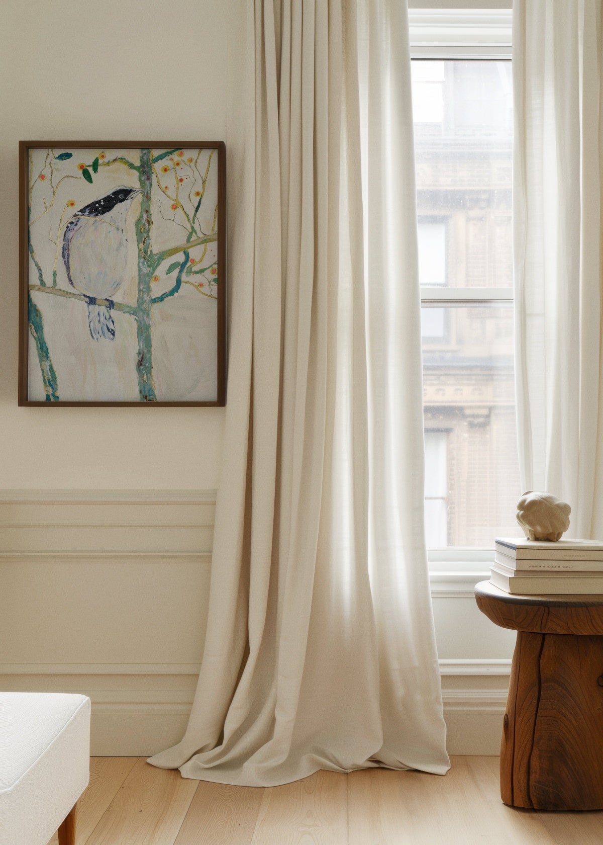 Bird no. 3 art print hanging near a tall window with flowing white curtains in a minimalist room