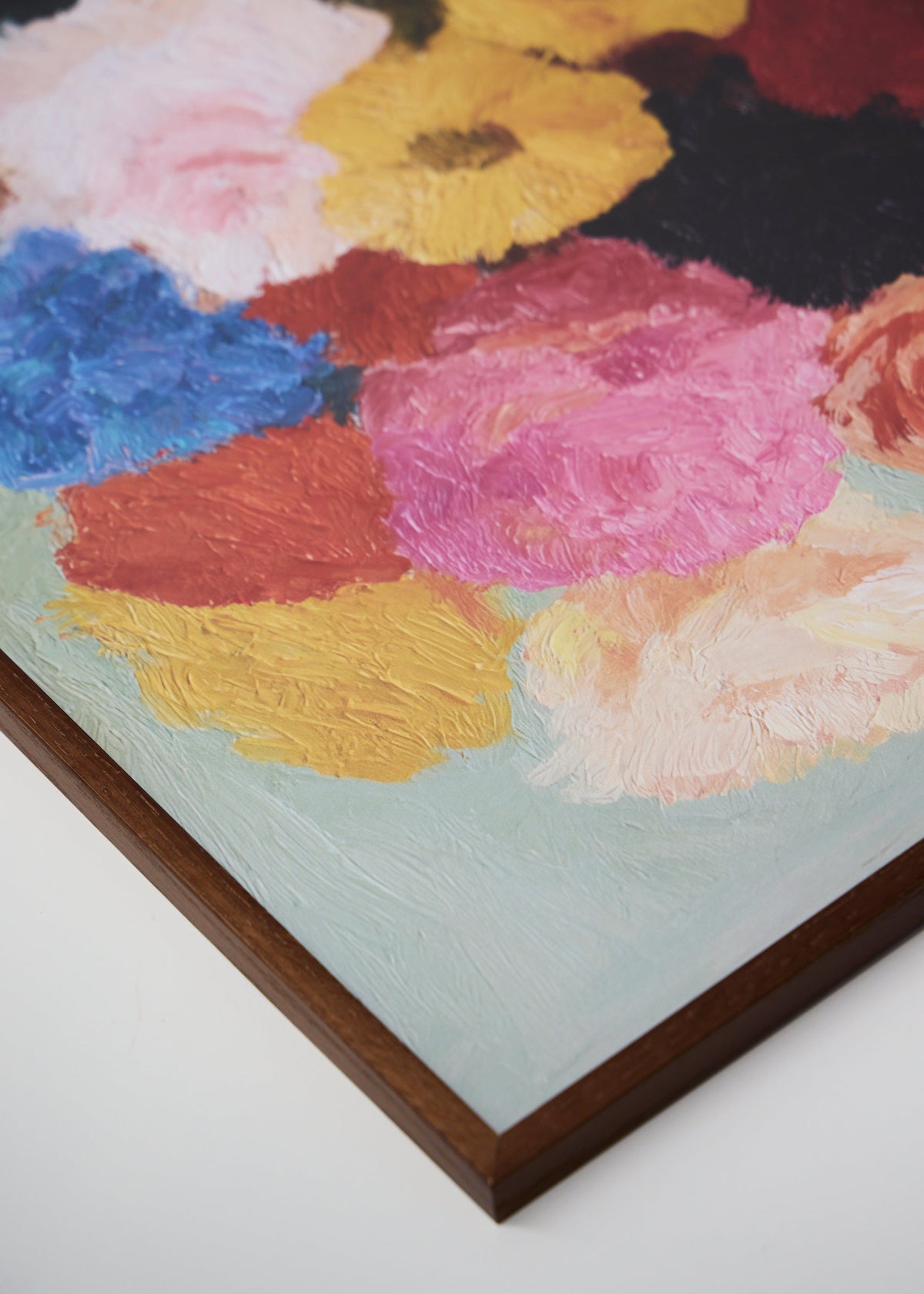 Colorful bouquet art print Blossoms styled in a dark oak frame, floral wall decor with painterly texture, perfect for cozy Nordic homes.