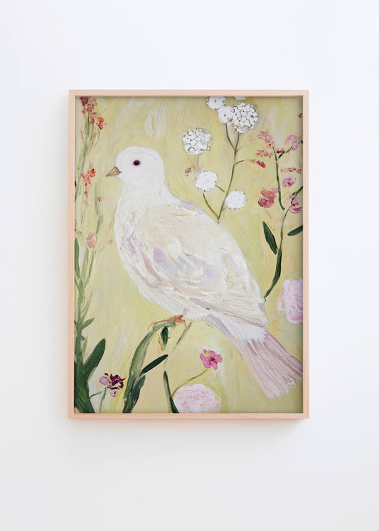 Garden Of Peace poster in natural oak frame styled on a white wall, featuring a white dove surrounded by soft pastel flowers in a bright Scandinavian interior by Hello Poster