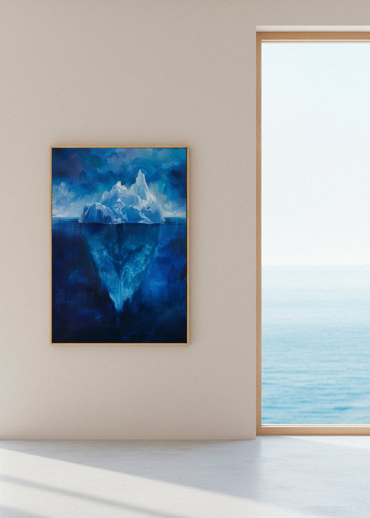 Large iceberg canvas hanging beside a window with ocean view, blue Arctic landscape wall art by HelloPoster.