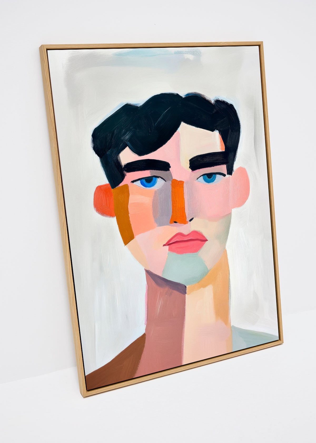 Canvas artwork Male featuring a colorful abstract male face in pink, orange and teal tones against a soft background.