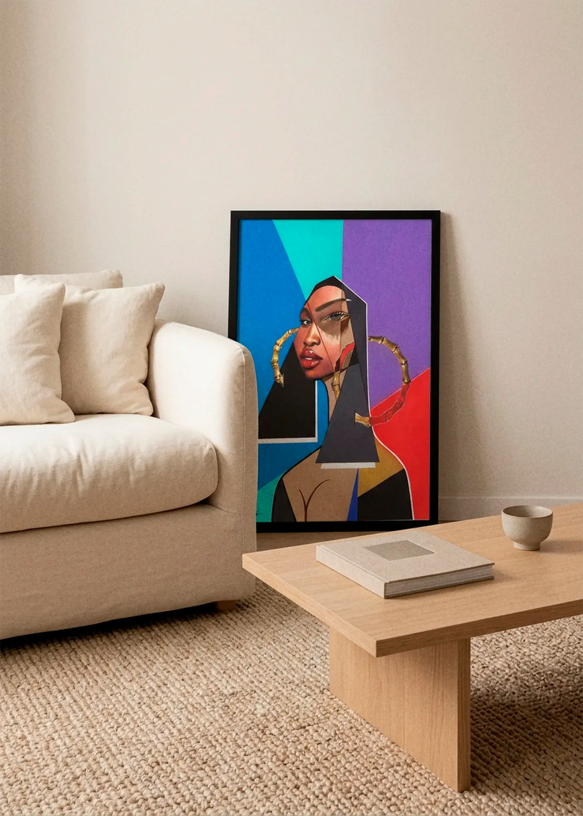 Modern Geometric Beauty by Manasseh Johnson Sr. art print featuring a striking female portrait with geometric shapes in blue, teal, purple and red, displayed in a black frame beside a cream sofa in a Scandinavian living room.