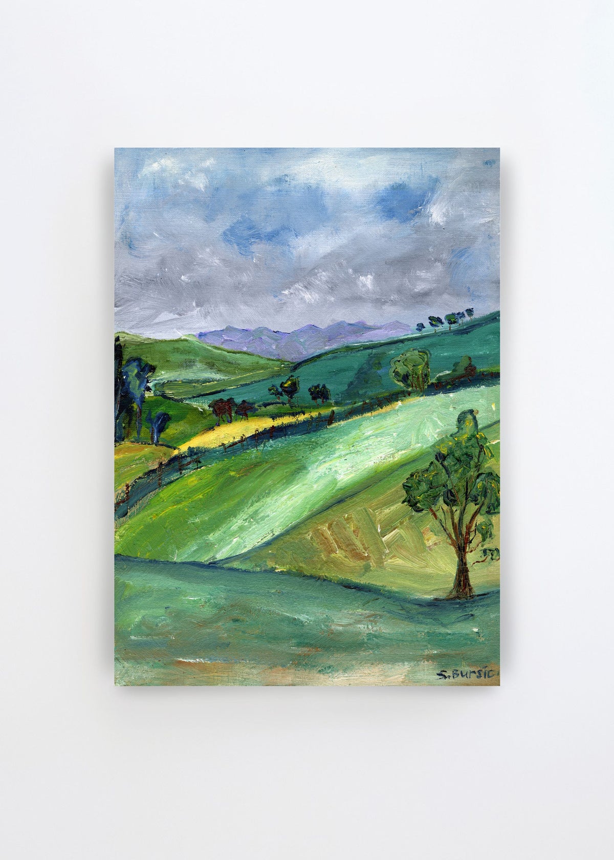 Rolling Green Hills by Sharyn Bursic – expressive landscape art poster featuring rolling green hills, scattered trees and a dramatic blue-grey sky.