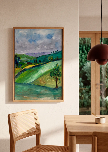 Rolling Green Hills by Sharyn Bursic featuring a painterly green countryside with rolling hills, scattered trees and a cloudy blue-grey sky.
