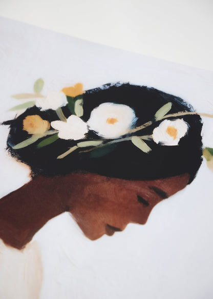 Saint poster on living room wall, feminine silhouette in pastel palette, modern and artistic touch in Scandinavian home.