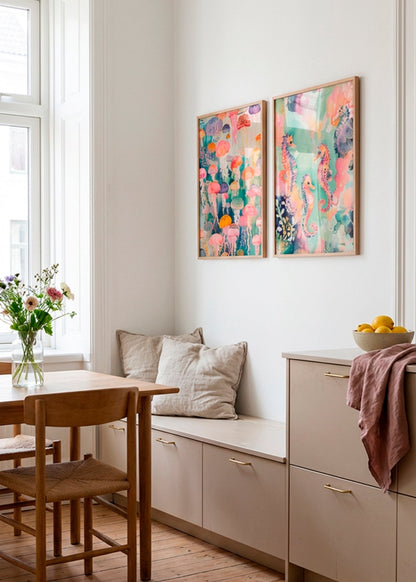 Framed Sea World and Under Water posters hanging in a bright Scandinavian kitchen, featuring colorful seahorses and jellyfish art in soft pastel tones.