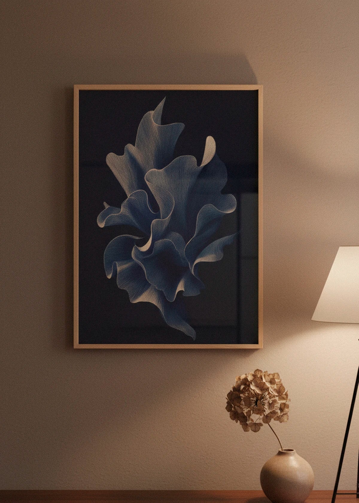 Shape No. 80 art print in oak frame displayed in a warm, dimly lit Scandinavian room with soft lamp light and natural decor.