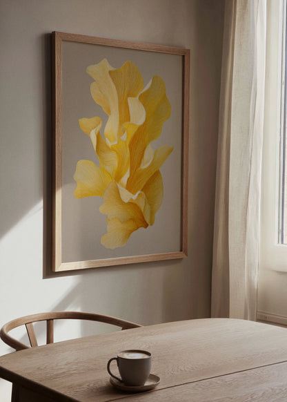 Framed botanical poster with abstract yellow flower illustration hanging on a beige wall in a bright, Scandinavian-style dining room with wooden chair and table.