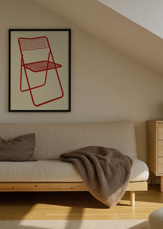 Ted Ned Chair Red poster in a black frame hanging in a modern Scandinavian living space, above a neutral sofa with soft blankets and natural light.