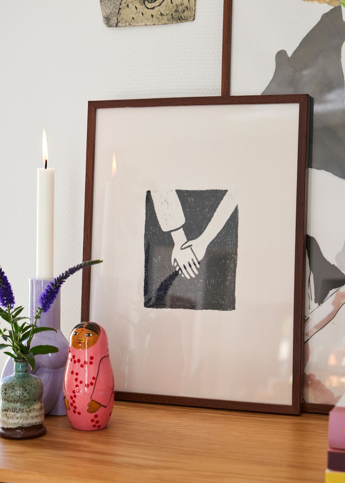 Togetherness poster styled with colorful ceramics, green plants, and a striped vase in a Scandinavian home interior.