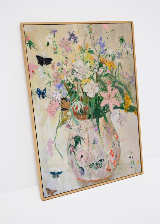 Wild Garden floral canvas print with butterflies, styled beside fresh daisies in soft daylight. Bright botanical wall art perfect for adding color to Scandinavian homes.