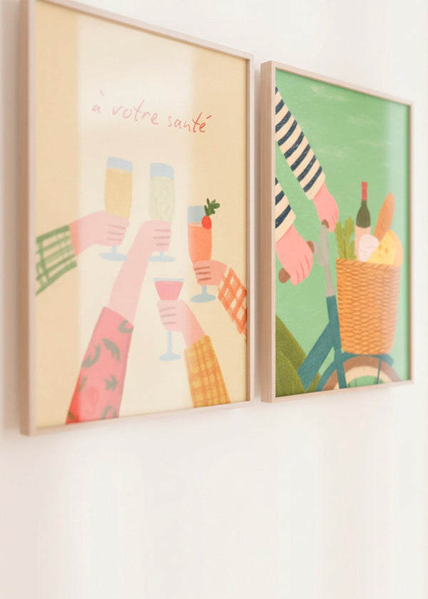 Close-up of “À votre santé” and “French Picnic” posters in oak frames, showing soft colours and Scandinavian styling.