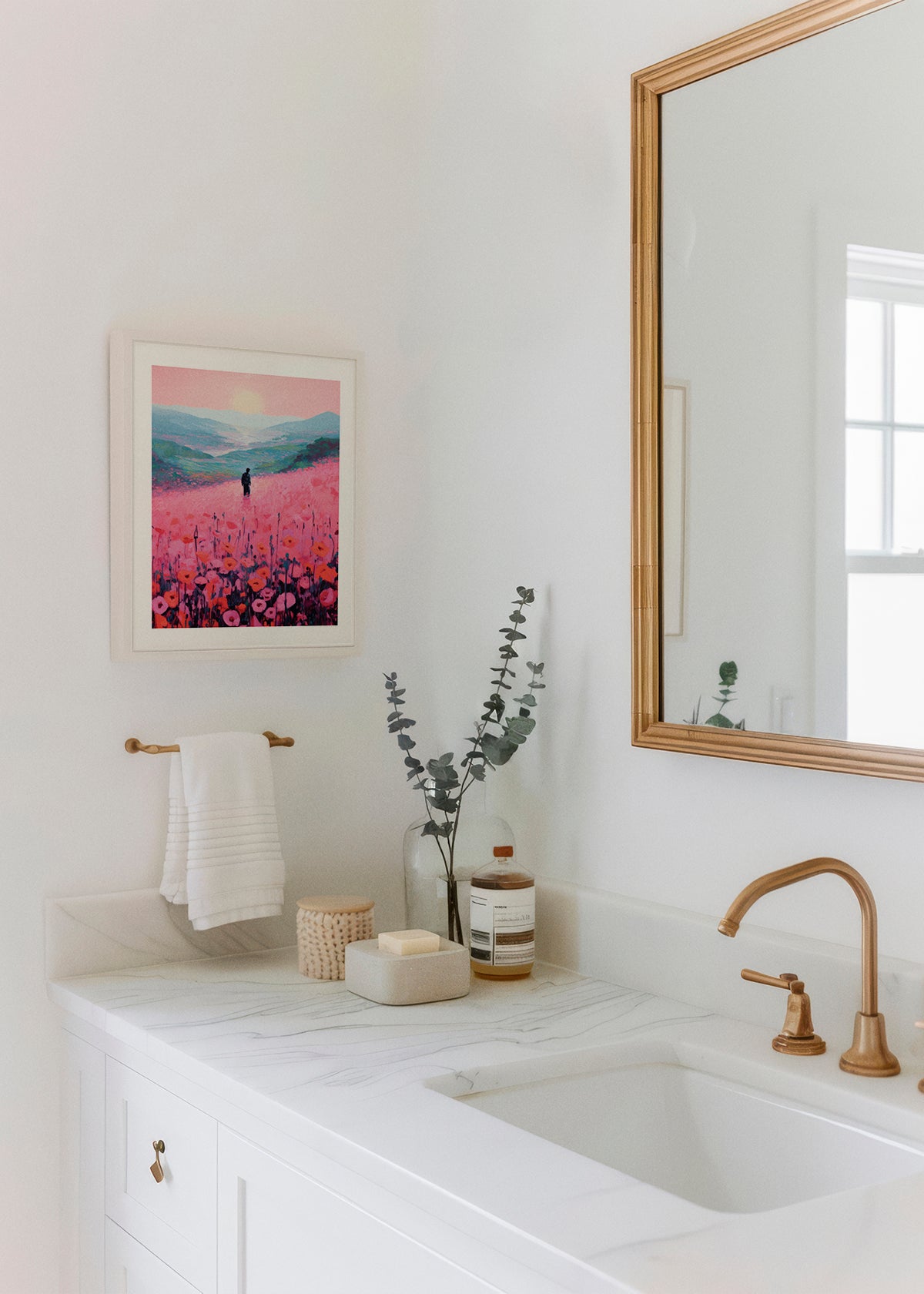 Poppy Field poster hanging in a modern white bathroom with brass fixtures and eucalyptus – adds a soft and calming touch.