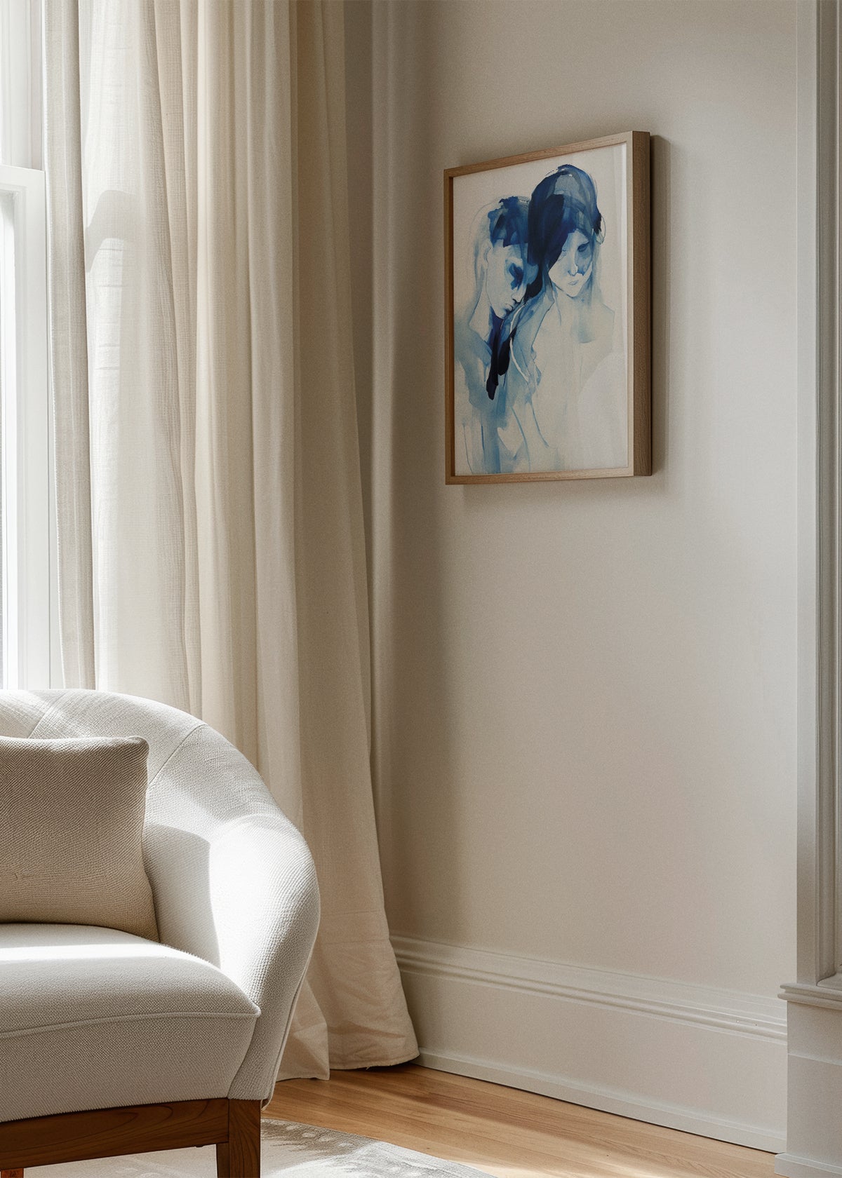 Dreamy watercolor illustration of two figures titled "Two", framed in wood and hanging beside light curtains in a cozy, elegant living room.