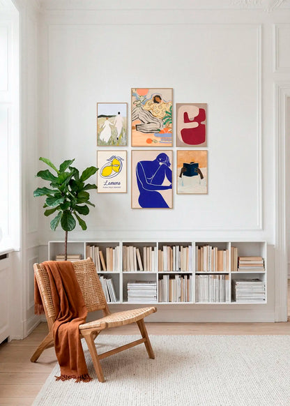 Us, Lazy Days, Lemons Paris Fruit Market, Red Geometric Shapes, Minimalist Blue Silhouette Figure and Must Read posters styled as a curated gallery wall in a Scandinavian living room